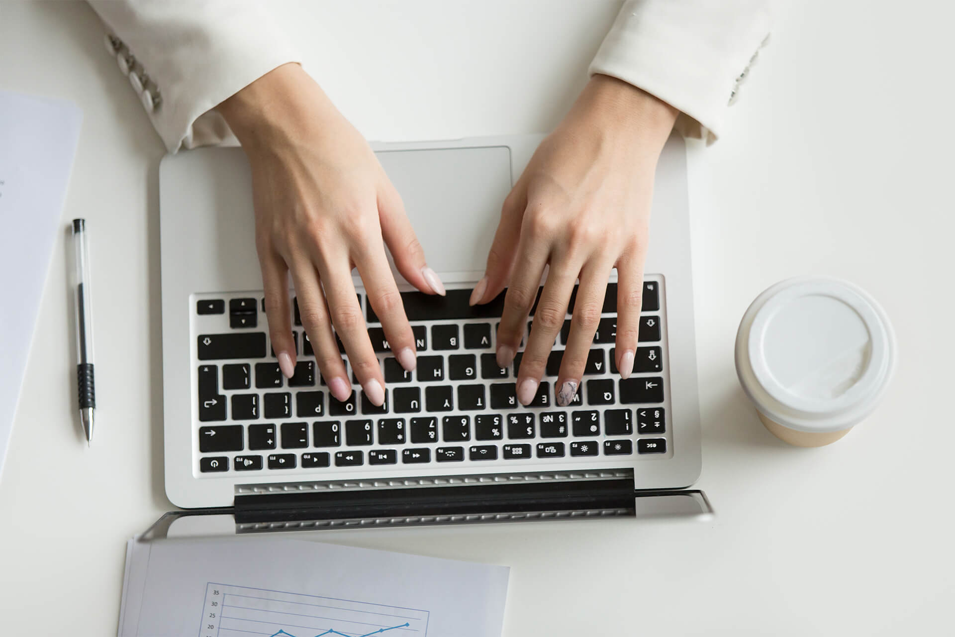 businesswoman-working-laptop-hands-typing-keyboard-top-view