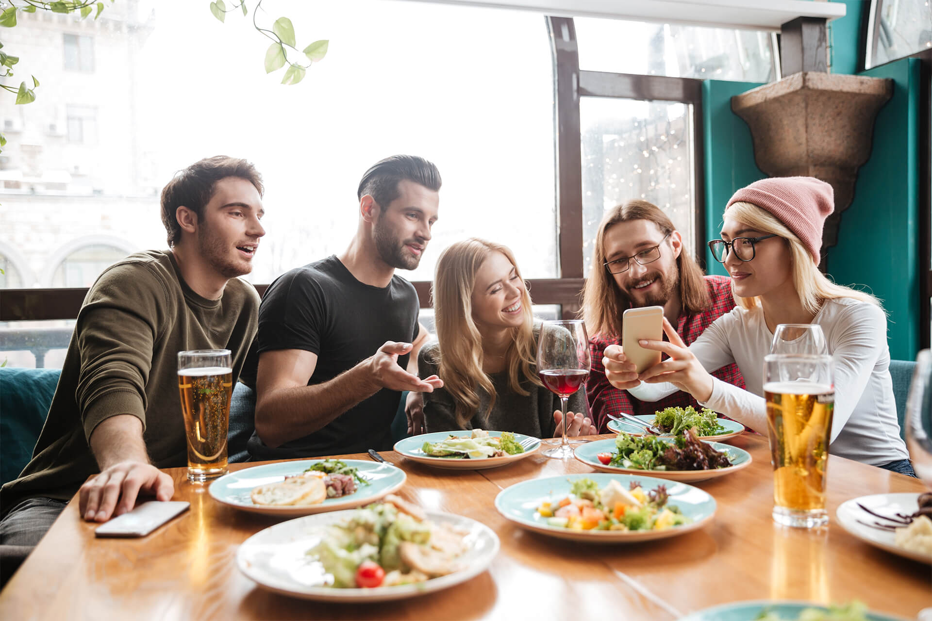 cheerful-friends-sitting-cafe-talking-with-each-other