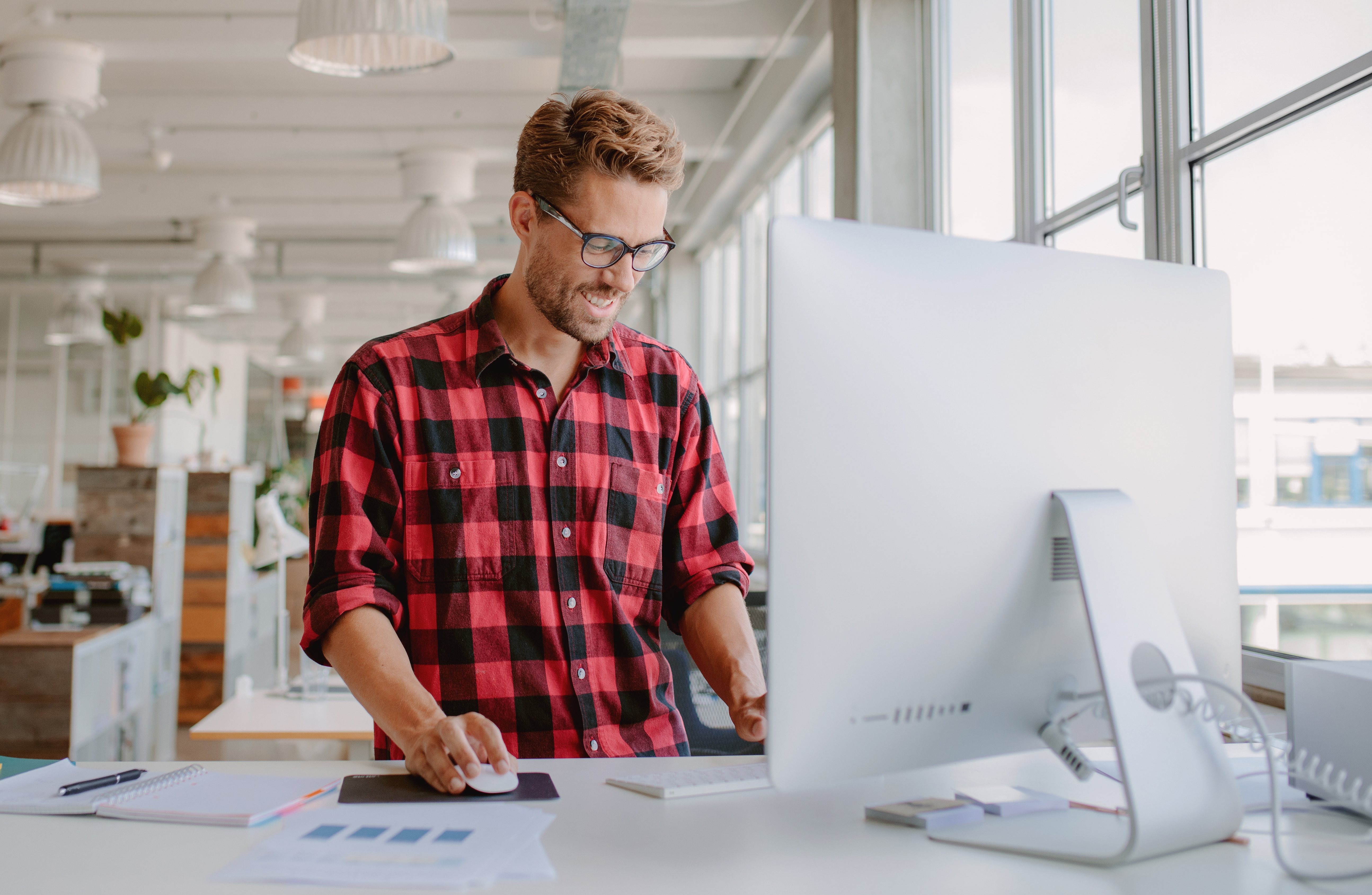 guy plaid computer smiling